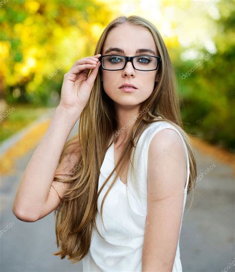 Attractive Blonde Woman Wearing Eyeglasses And White Blouse At Summer