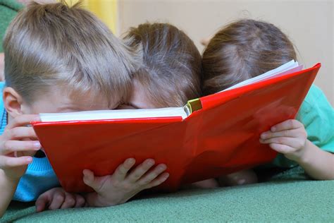 Children Reading A Book Business In The Community