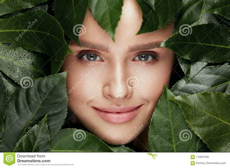 Natural Beauty Beautiful Woman Face In Green Leaves Stock Photo