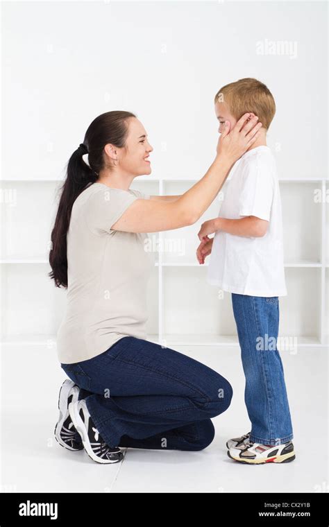 Mother Kneeling Down And Comforting Son Stock Photo Alamy
