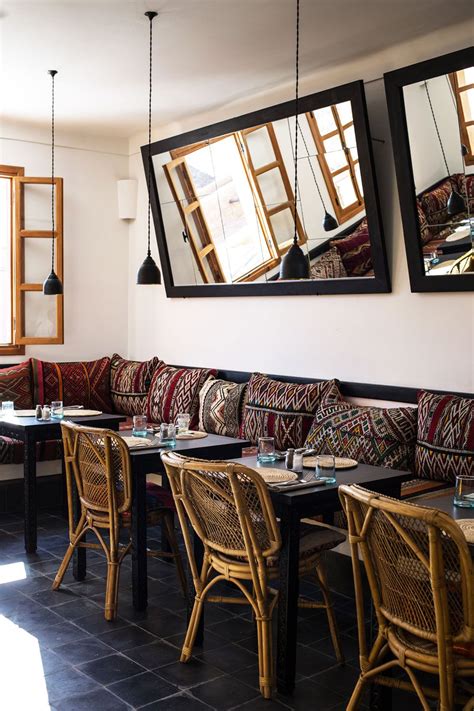 Dining Banquette Inside Nomad Restaurant With Woven Moroccan Pillows