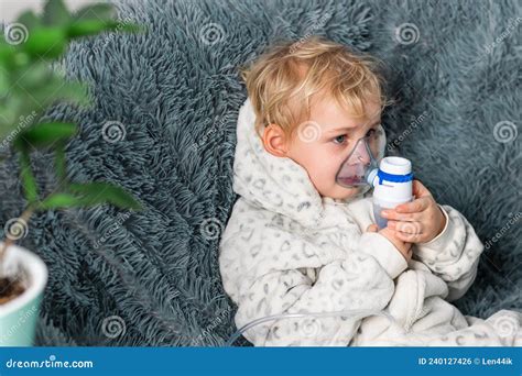 Cute Baby Boy Makes Inhalation With A Nebulizer Equipment Sick Child