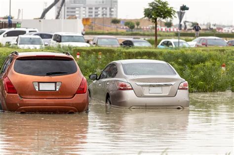 Cars Stuck In Water In A Flooded Parking Lot After Heavy In Rain In