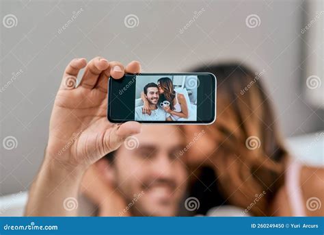 Selfies To Showcase Their Love A Loving Young Couple Taking Selfies Together At Home Stock