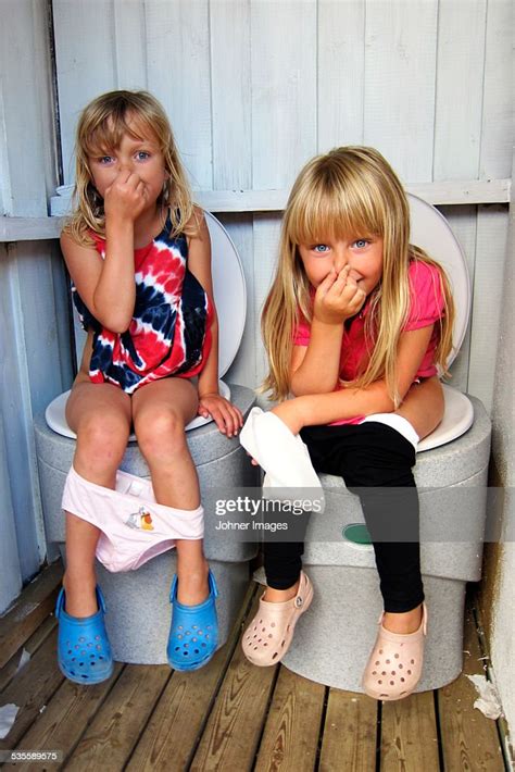 Girls Sitting On Toilets Stockfoto Getty Images