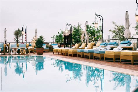 Rooftop Swimming Pool With Empty Sunbeds By Stocksy Contributor