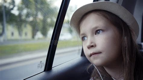Little Girl Looking Out From Car Window At Sunny Day Stock Image