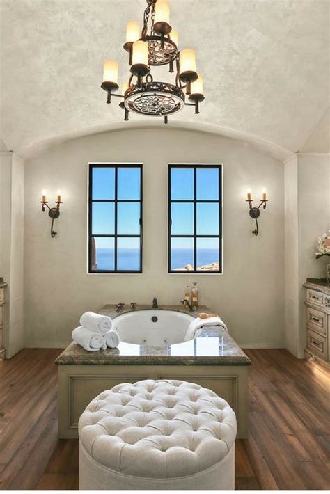 A Bathroom With A Large Tub And Two Windows