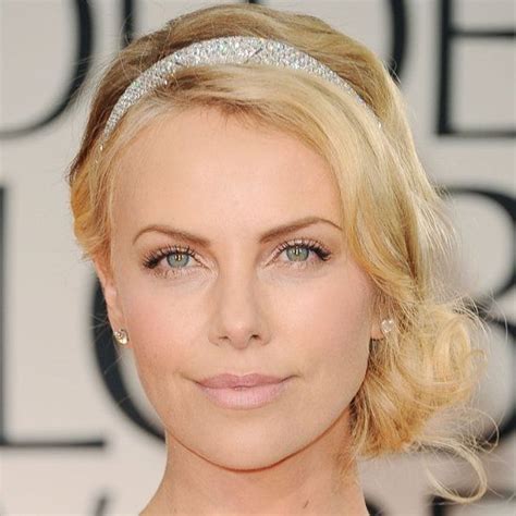 Charlize Therons Wavy Blonde Hair In Romantic Side Chignon Hairdo