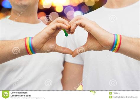 Gay Couple With Rainbow Wristbands And Hand Heart Stock Image Image