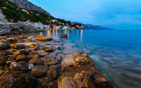 Dalmatia Croatia Rocky Beach And Small Village Near Omis In The Evening