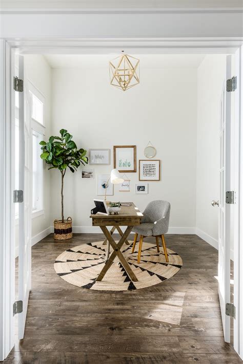 Home Office With White Walls Bold Chandelier And Wood Floors Desk Hgtv