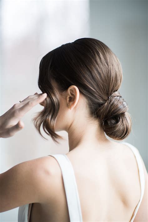 Modern Simple Low Bun Updo With Bangs Wedding Hairstyles And Makeup