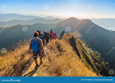 Beautiful Landscape With Trekkers Walking On Mountain Ridge In Sunset