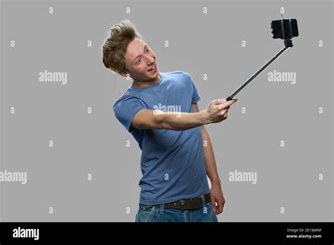 Funny Teen Boy Using Selfie Stick Stock Photo Alamy