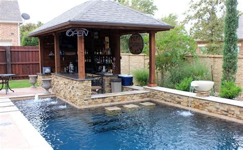 This Custom Swimming Pool Features A Unique Outdoor Bar Area With Top