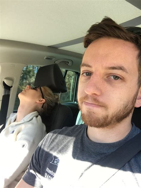 a man sitting in the back seat of a car next to a woman