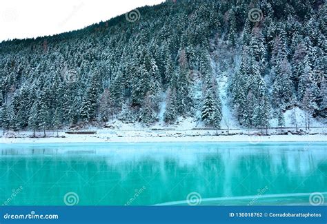 The Beautiful Frozen Turquoise Lake And The Snow Covered Forest Stock