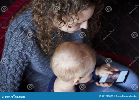 Mom Shows Her Little Son How To Use A Mobile Phone Stock Photo Image