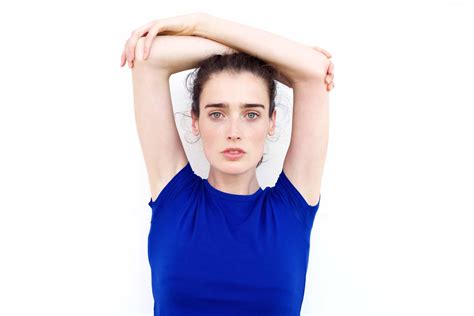 Serious Young Woman Staring With Arms Above Her Head Jody Moore