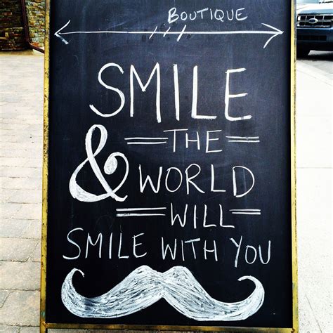 A Chalkboard Sign That Says Smile And The World Will Smile With You
