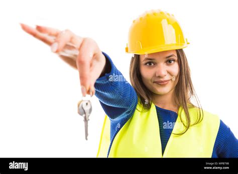 Young Woman Engineer Or Architect Offering House Keys And Smiling As