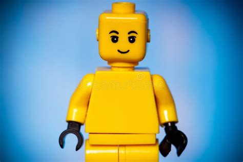 Yellow Lego Figure With A Smile On His Face On A Blue Background With A