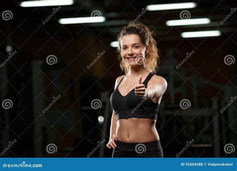 Cheerful Sports Lady In Gym Showing Thumbs Up Gesture Stock Photo Image Of Midsection Loss