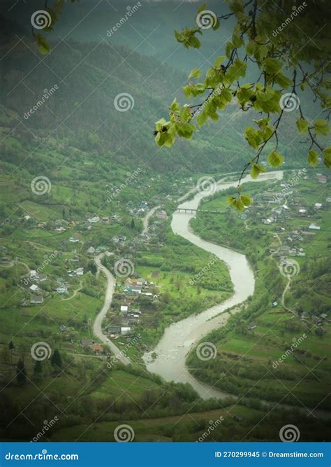 Top View Valley Of Meandering River Among Small Mountain Village Stock