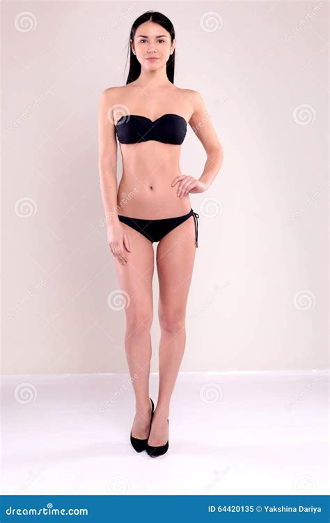 Beautiful Woman With Perfect Body With Dark Straight Hair Wears Black Bikini Stock Image