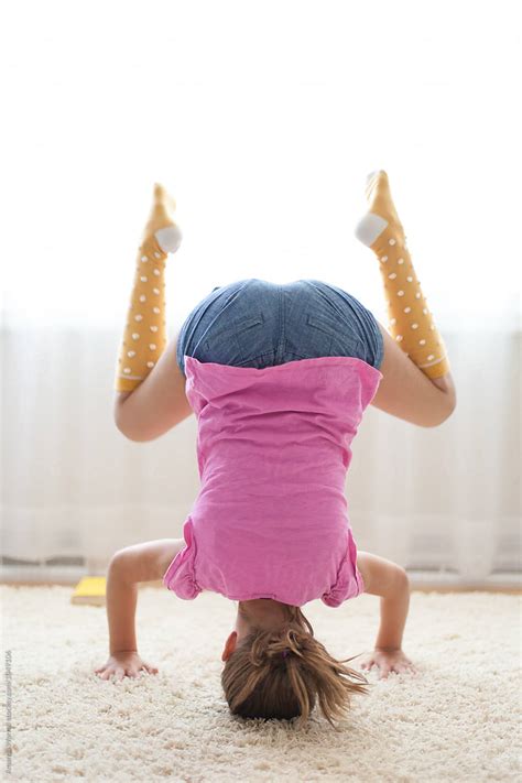Tween Girl Practicing A Yoga Headstand By Stocksy Contributor Amanda