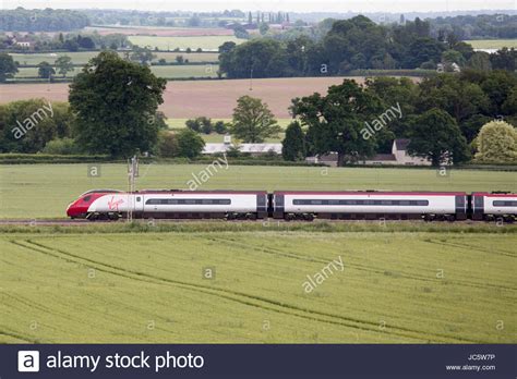 A Virgin High Speed Train Passing Through Countryside Near Grendon