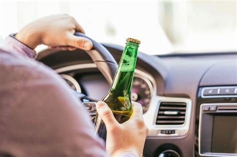 Premium Photo Man Drinking Alcohol While Driving The Car