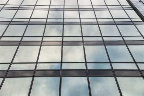 Modern High Rise Building Glass Wall With Blue Sky Reflection Stock