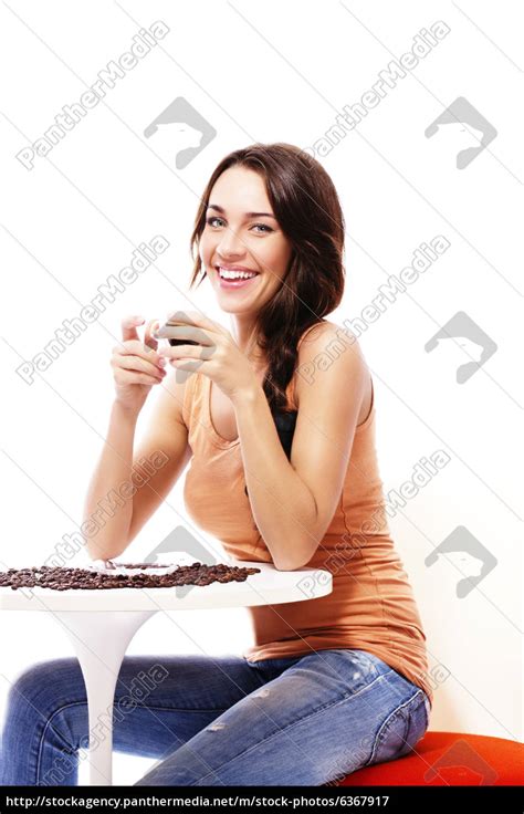 Fröhliche Frau Sitzt An Einem Tisch Mit Espresso Stockfoto 6367917 Bildagentur Panthermedia