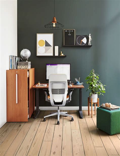 An Office With Green Walls And Wooden Floors