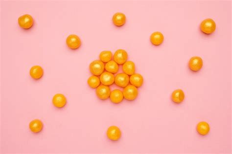 Premium Photo Sweet Yellow Candies On A Pink Round Sweet Food