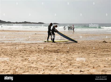 Two Surfers On Porthmeor Beach St Ives Cornwall Uk May 2021 Stock