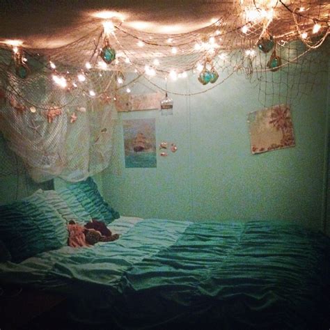 A Bedroom With Lights Strung From The Ceiling And A Teddy Bear Laying