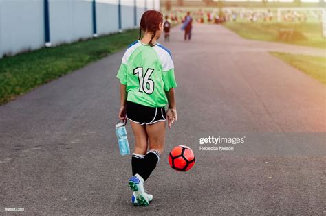 Girl Dribbling Soccer Ball To Her Field To Begin Play High Res Stock
