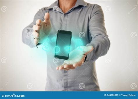 Man With Phone Floating Between His Hands And Holographic Digital Icons