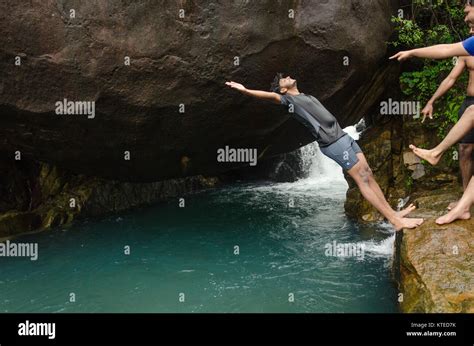 Young Adult Boy About To Fall In Reverse Off The Cliff After A Push