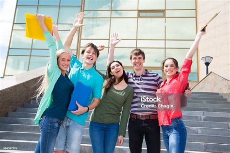 Excited Students With Arms Outstretched Outdoors Stock Photo Download