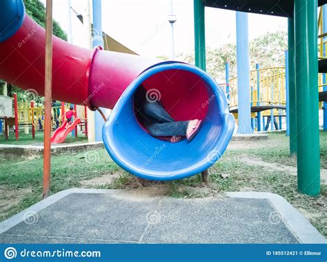 Kids From Behind At The Playground Tunnel Slide Stock Image Image Of