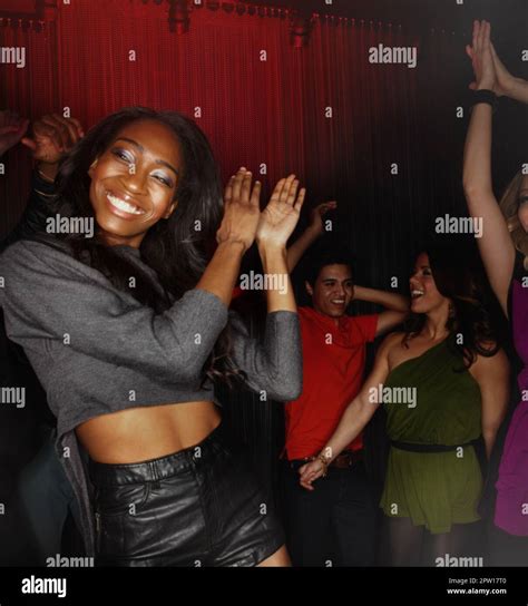 black woman dancing and clapping hands in party celebration event or disco at the night club