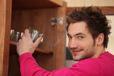 Man Taking Out Glass From Cupboard Picture Picture And Hd Photos Free