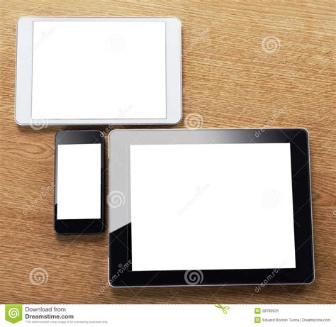 Different Types Of Digital Tablet And Smart Phone On A Desktop Stock