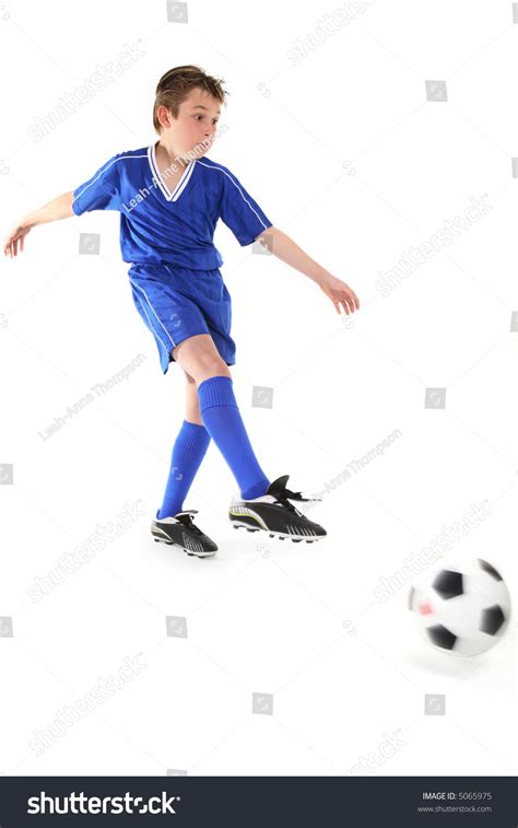A Boy Kicks A Soccer Ball Motion In Ball And Kicking Leg Stock Photo