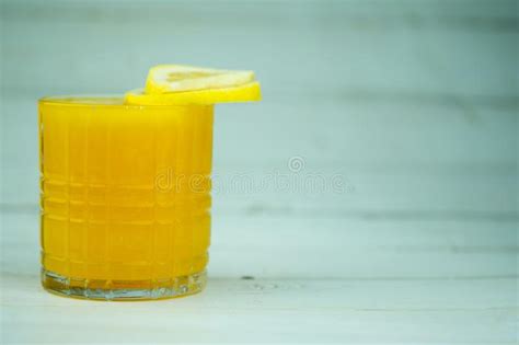 Orange Juice In Transparent Glass With Lemonade Sliced Lemon Stock