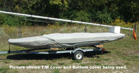 Scow — a scow, in the original sense, is a flat bottomed boat with a blunt bow, often used to haul garbage or similar bulk freight; Mc Scow Trailing/Mooring Cover -- One Design Sailboat Covers -- The Sailors Tailor, Inc.